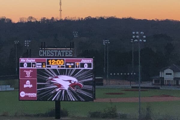 Chestatee's custom LED digital scoreboard with a sunset behind